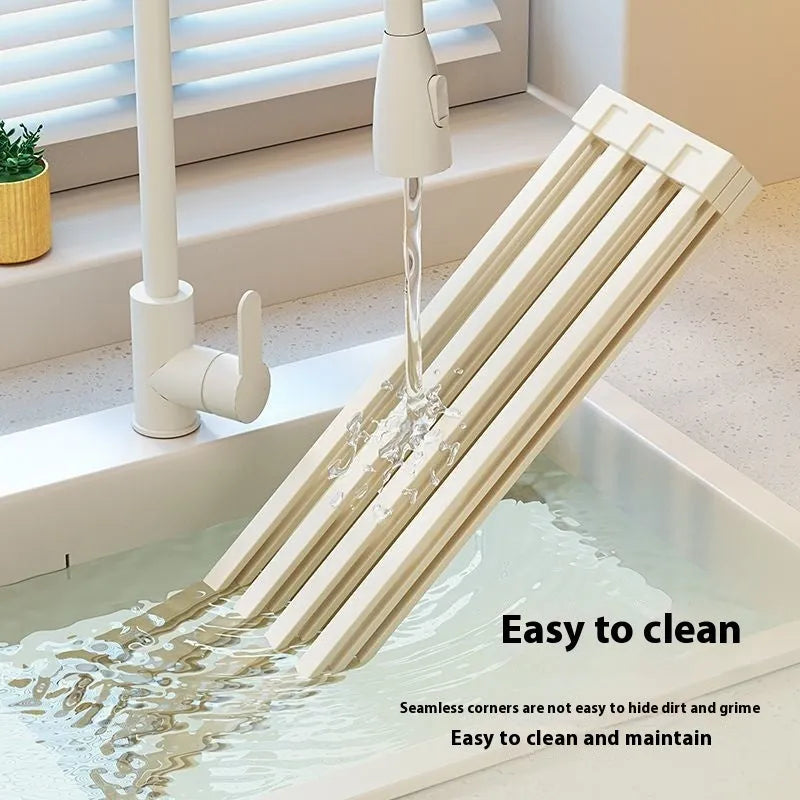 Foldable stainless steel kitchen draining rack in milky white finish showing tri-fold mechanism