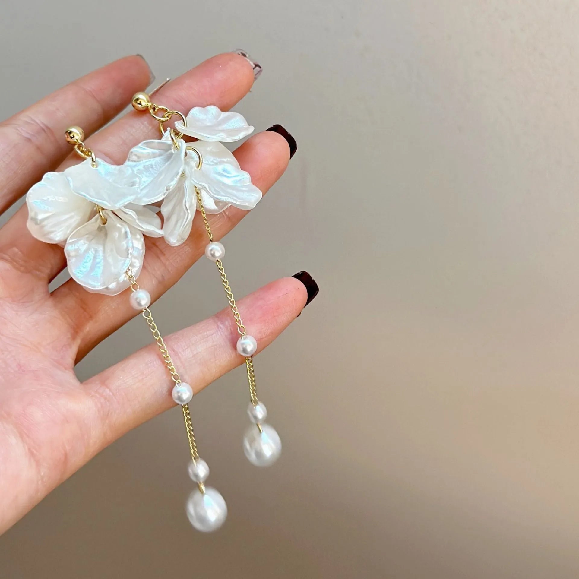 Women's acrylic shell pearl tassel earrings showing four different clip style options