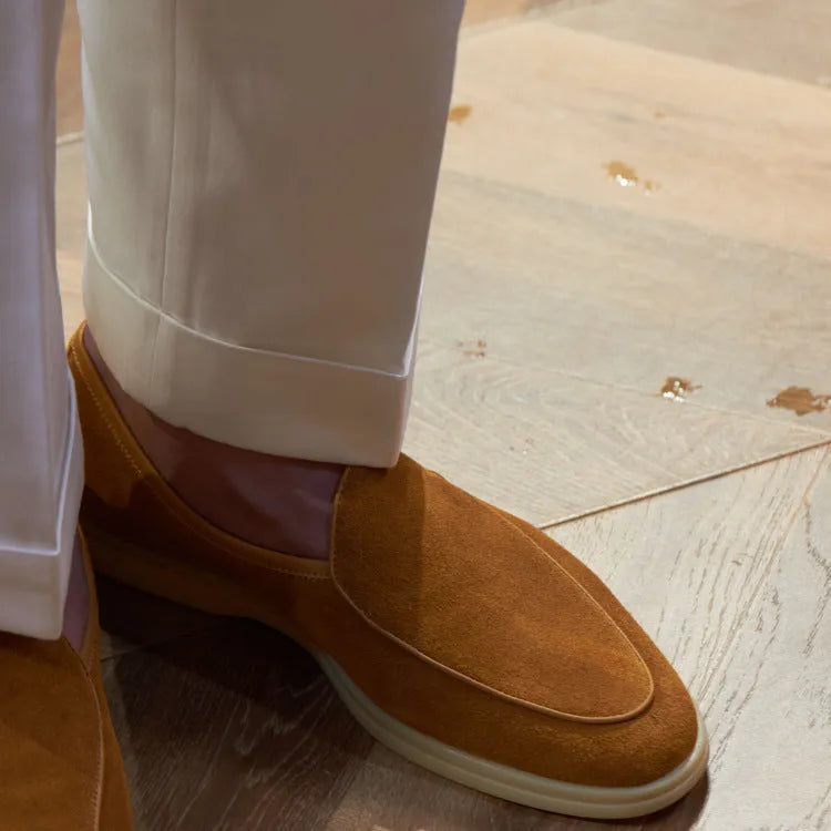 Men's brown genuine leather loafers with a TPR sole on a white background.