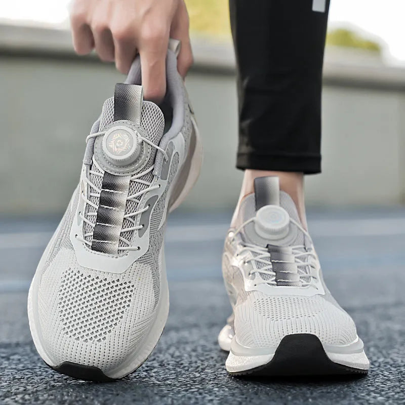 Men's low-top running shoes with rotating button buckle on beige Fly-kit mesh upper and TPU sole.