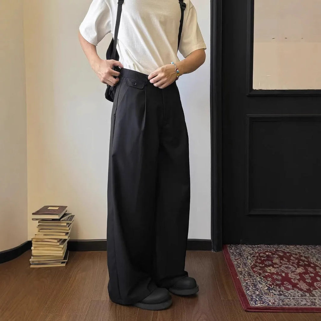 Men's straight-leg casual trousers in polyester blend fabric showing drape and wider cut design