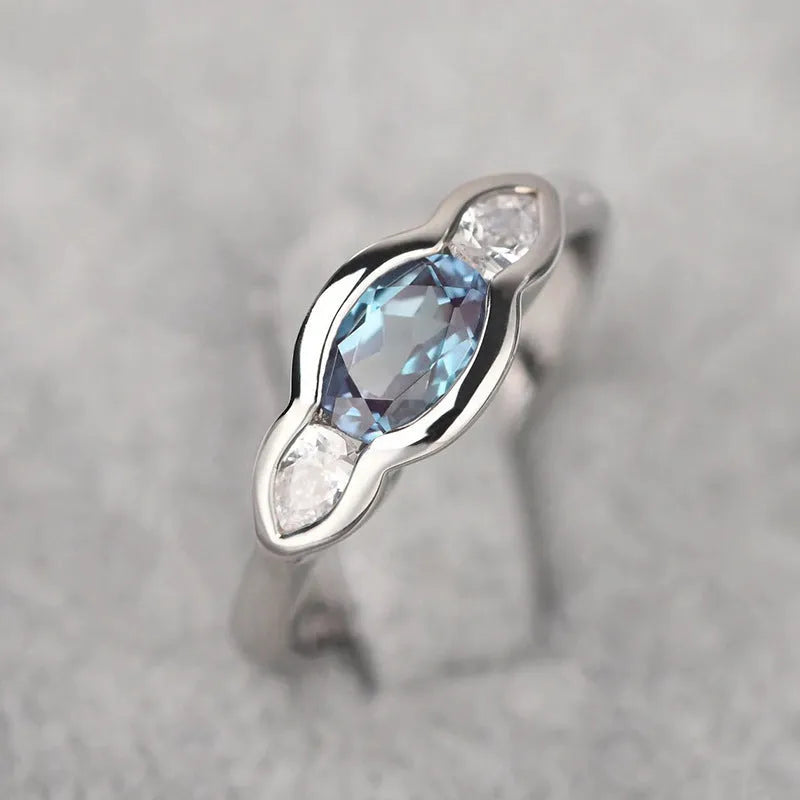 Geometric ellipse ring with zircon inlay in white gold colour on copper