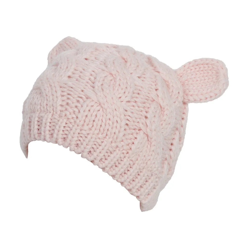 Hand-made chunky wool beanie with 3D knitted cat ears on a white background.