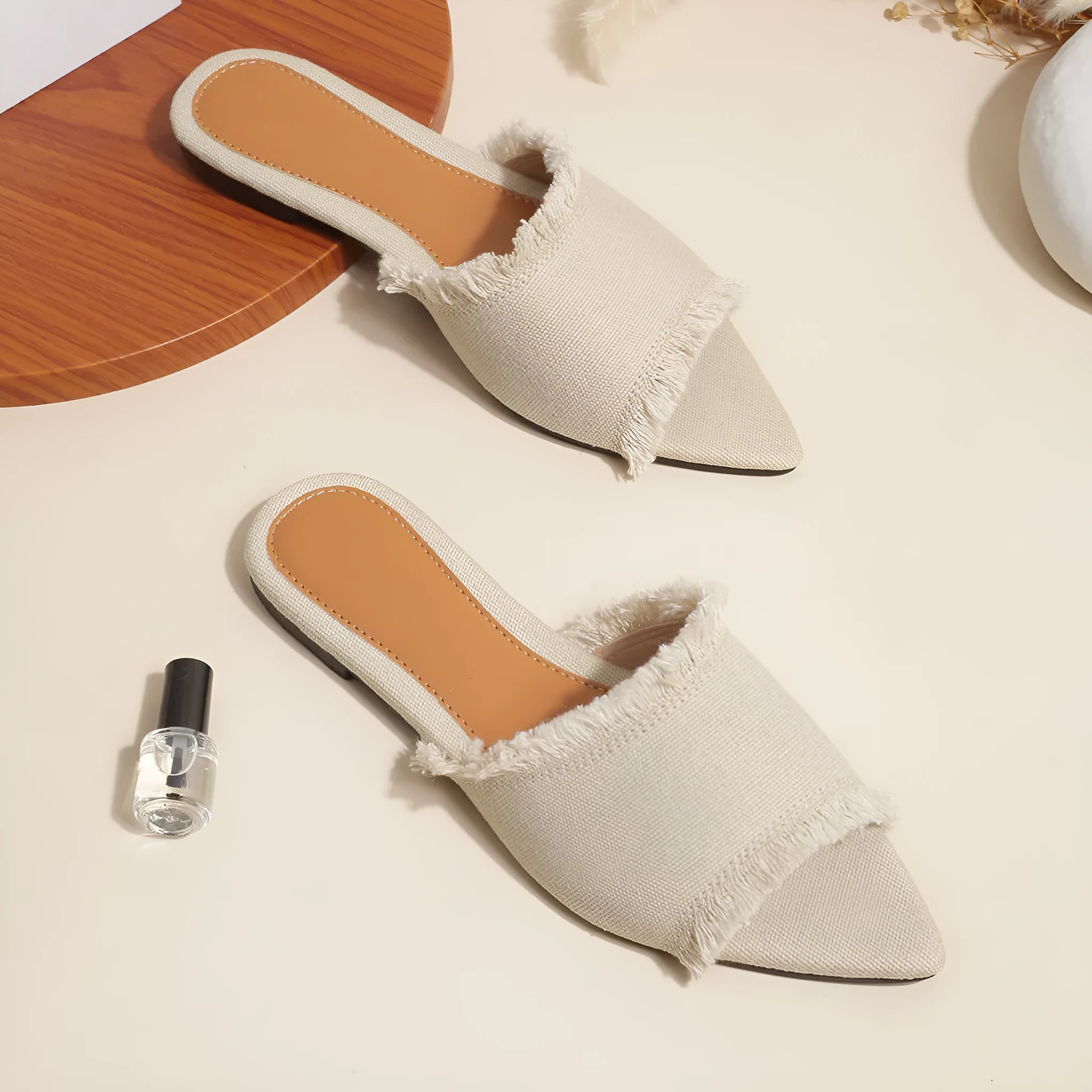Women's denim flat slippers with tassel detail and leather lining in various colours.