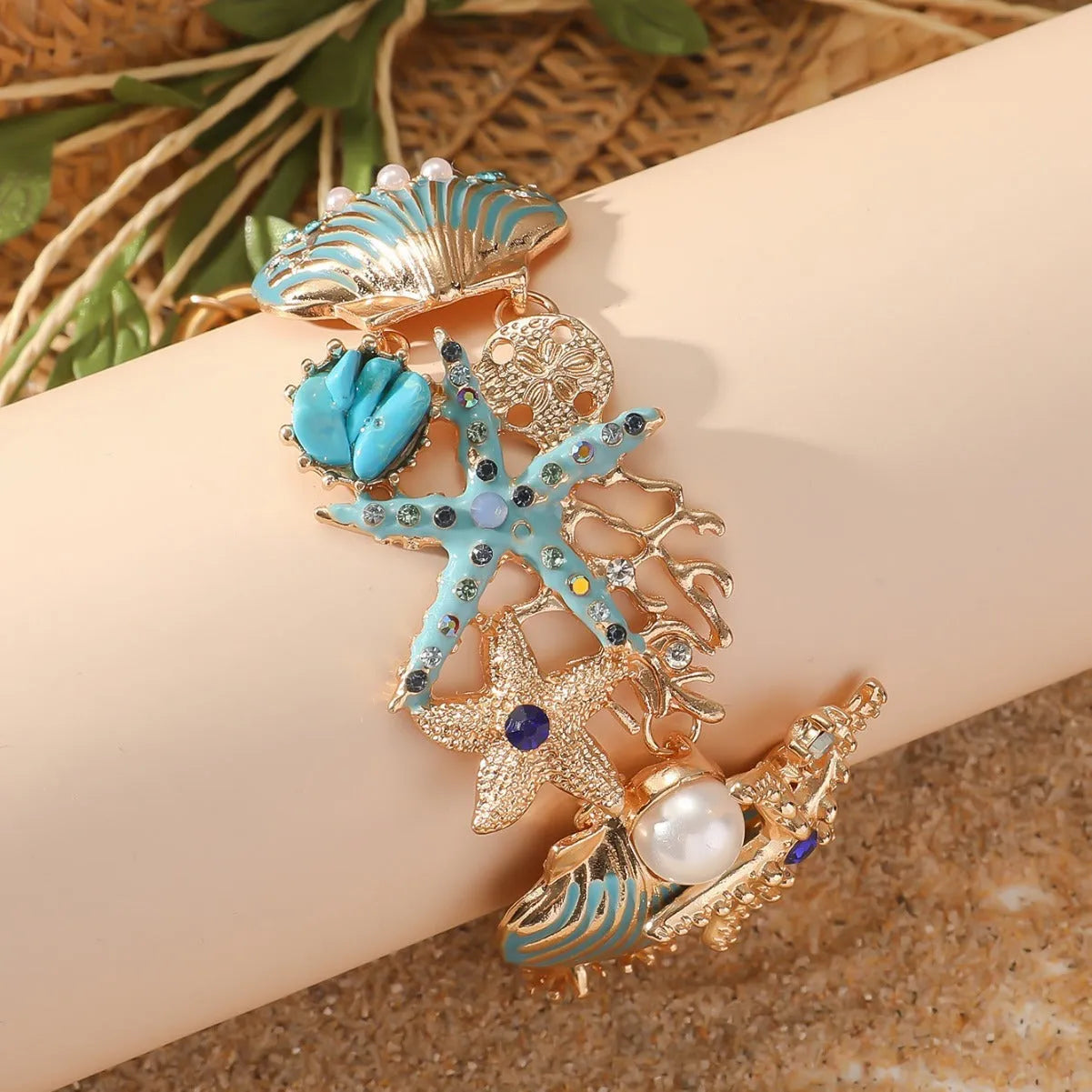 Women's alloy rhinestone bracelet with boat anchor, shell, and starfish charms in blue.