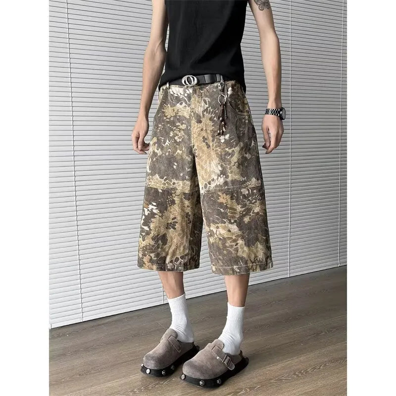Yellow women's cropped jeans with a large snake camouflage pattern tooling print on the denim fabric.