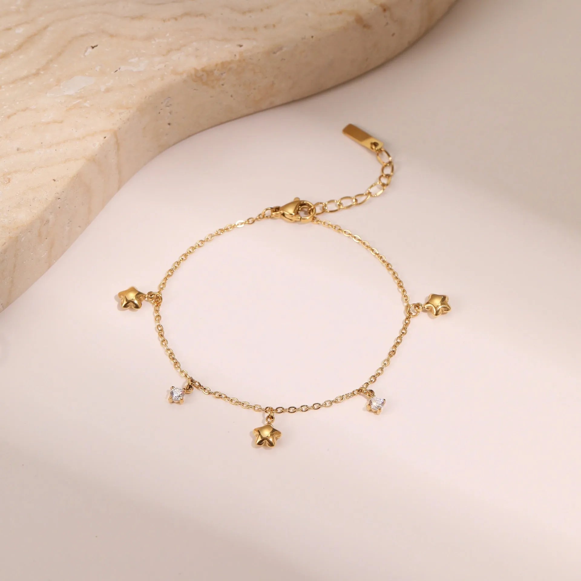 Women's titanium steel bracelet with gold plating and geometric star pendant