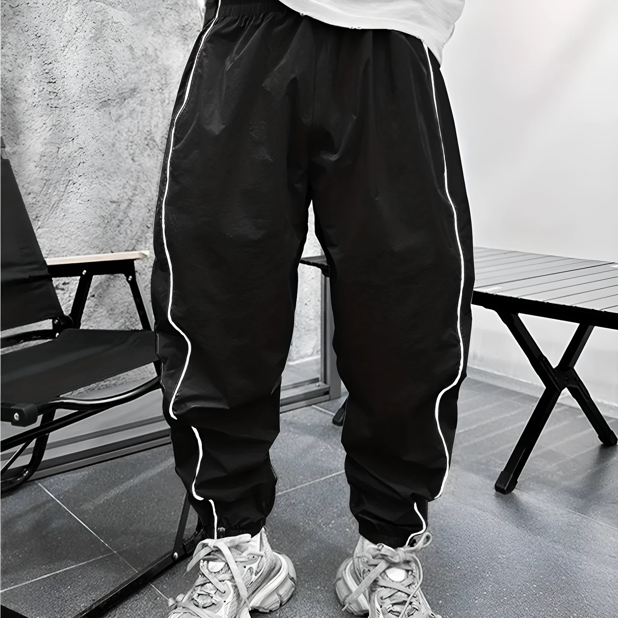 Man wearing blue bamboo fibre casual trousers with a cropped leg and loose fit.