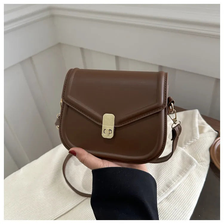 Soft PU shoulder messenger bag in horizontal square clamshell shape with niche texture.