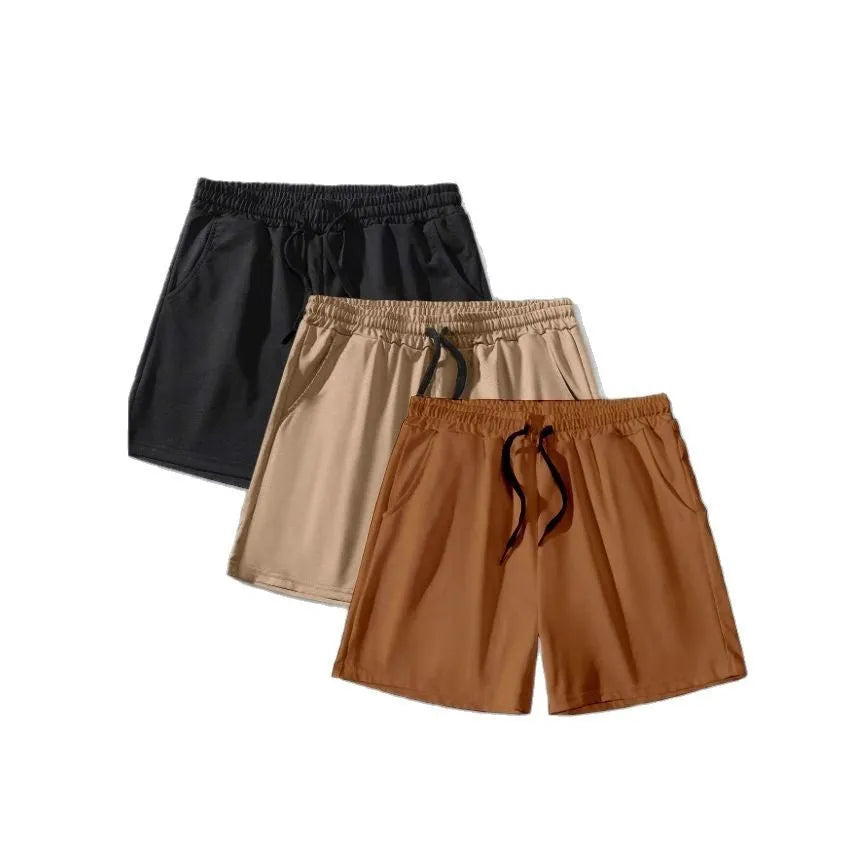 Three pairs of men's solid colour shorts in black, khaki and light brown with drawstring waists