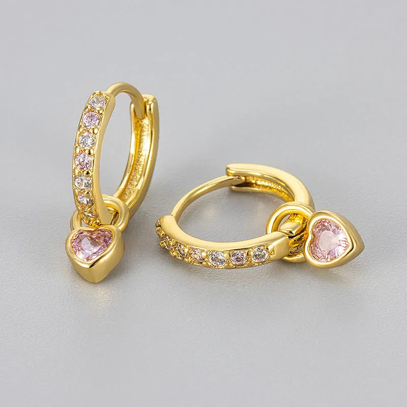 Women's fashion earrings with heart-shaped drops containing coloured gemstones in gold or white gold colour settings