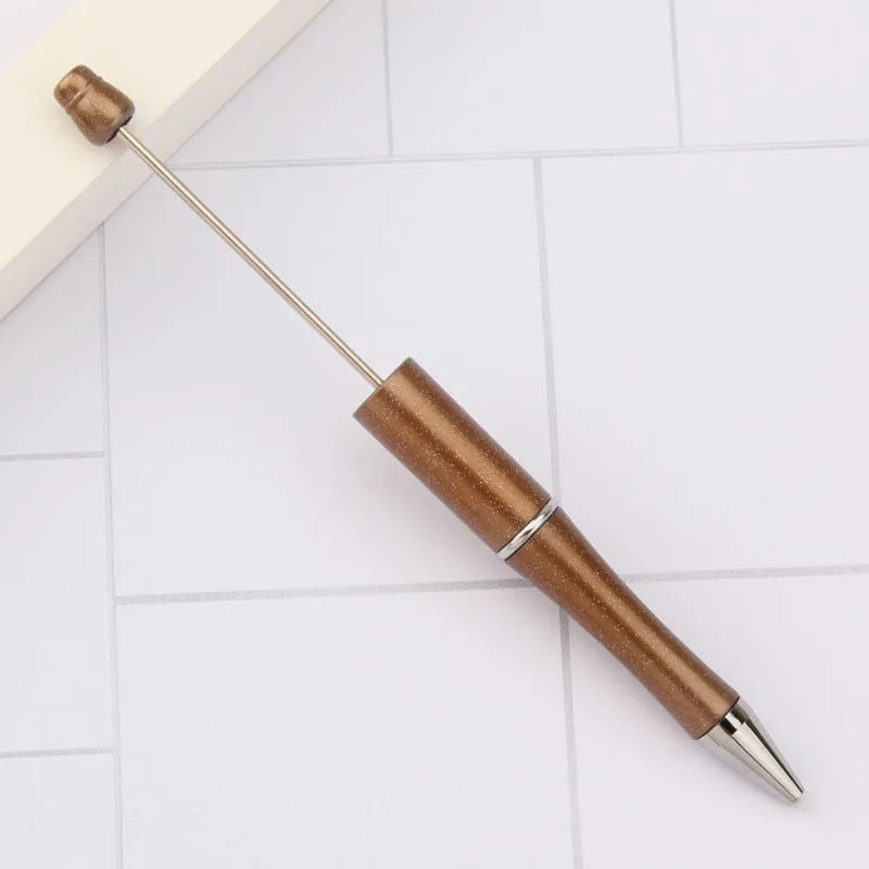Creative ballpoint pen with multicoloured spinning plastic beads on a steel wire frame.