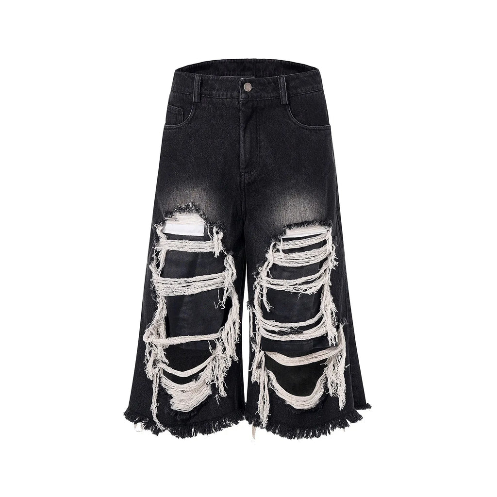 Black women's cropped wide leg jeans with a distressed patch detail on the leg.