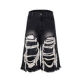 Black women's cropped wide leg jeans with a distressed patch detail on the leg.