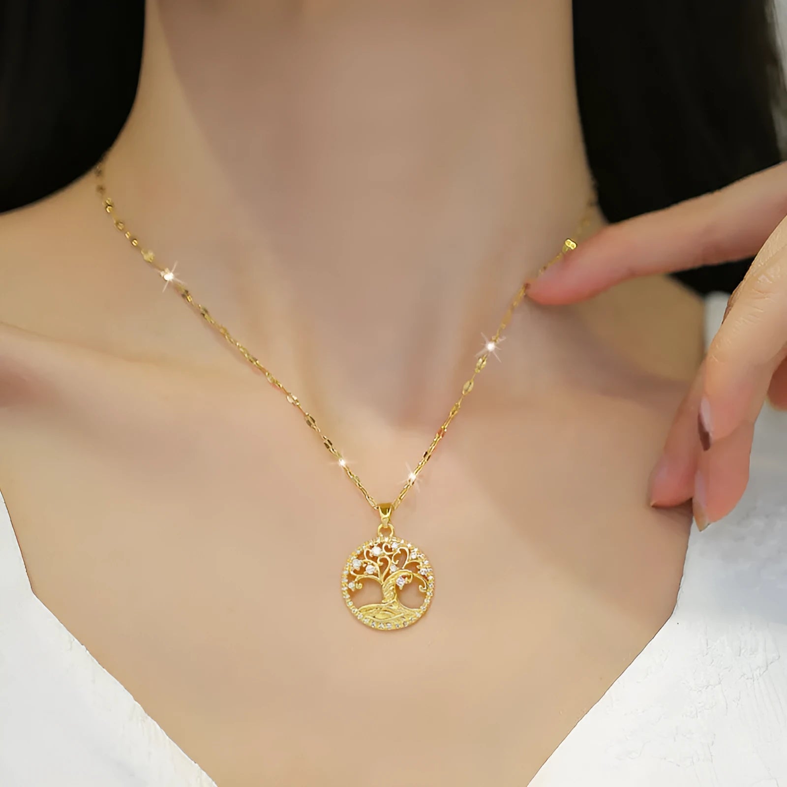 Gold plated Lucky Tree Light necklace with rhinestone details and a Mother Pearl pendant on an adjustable chain.