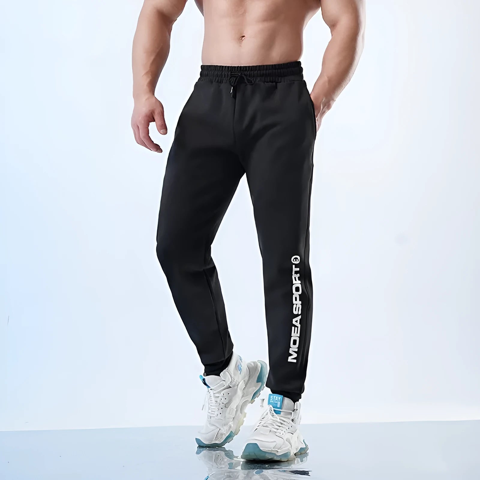 Men's grey sweatpants with ankle ties showing mid-waist design and polyester-spandex fabric