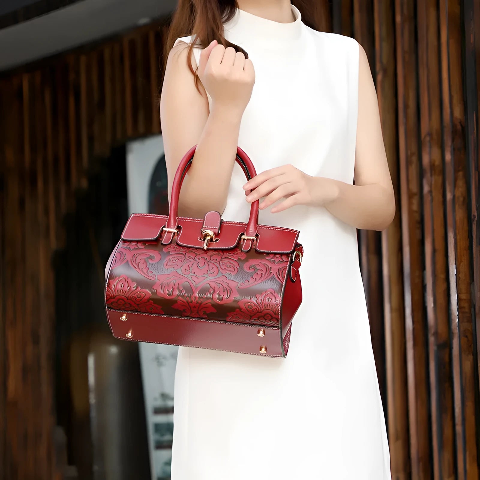 Red genuine leather oval crossbody bag with embossed design and multiple interior pockets