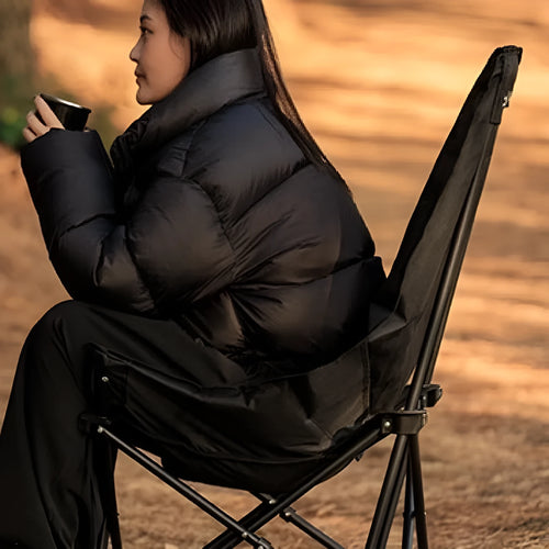 Night black portable camping recliner folding chair in moon chair style, shown both set up and folded.