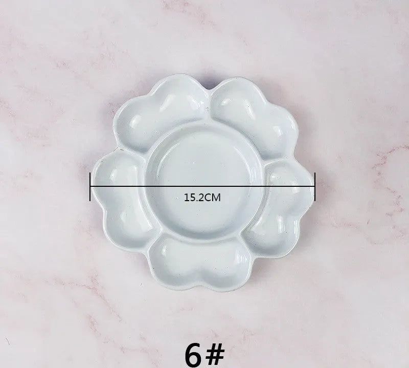 White ceramic plum blossom shaped artist's palette for paint mixing
