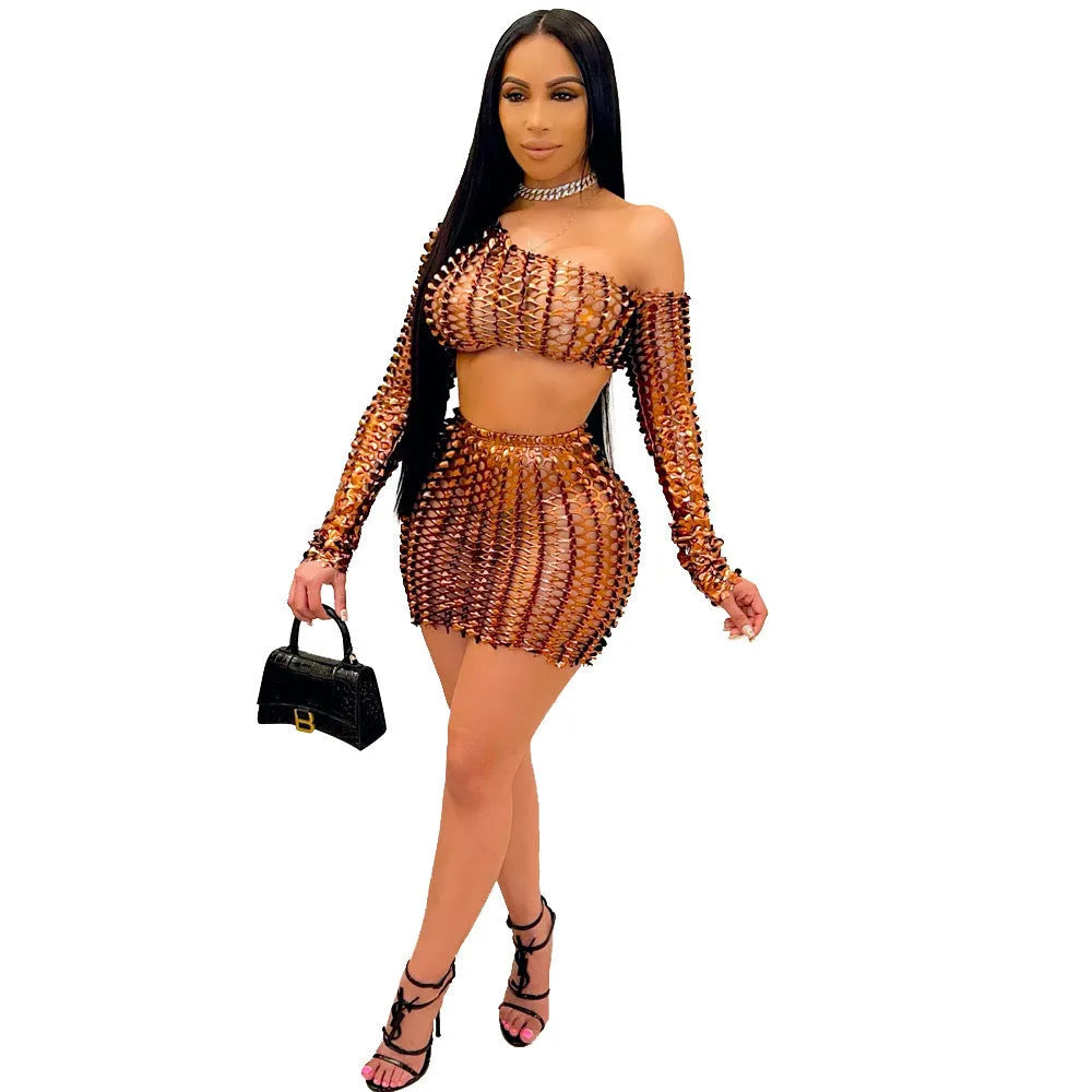 Women's black hollow-out two-piece set featuring a sleeveless top and short skirt with splicing detail.