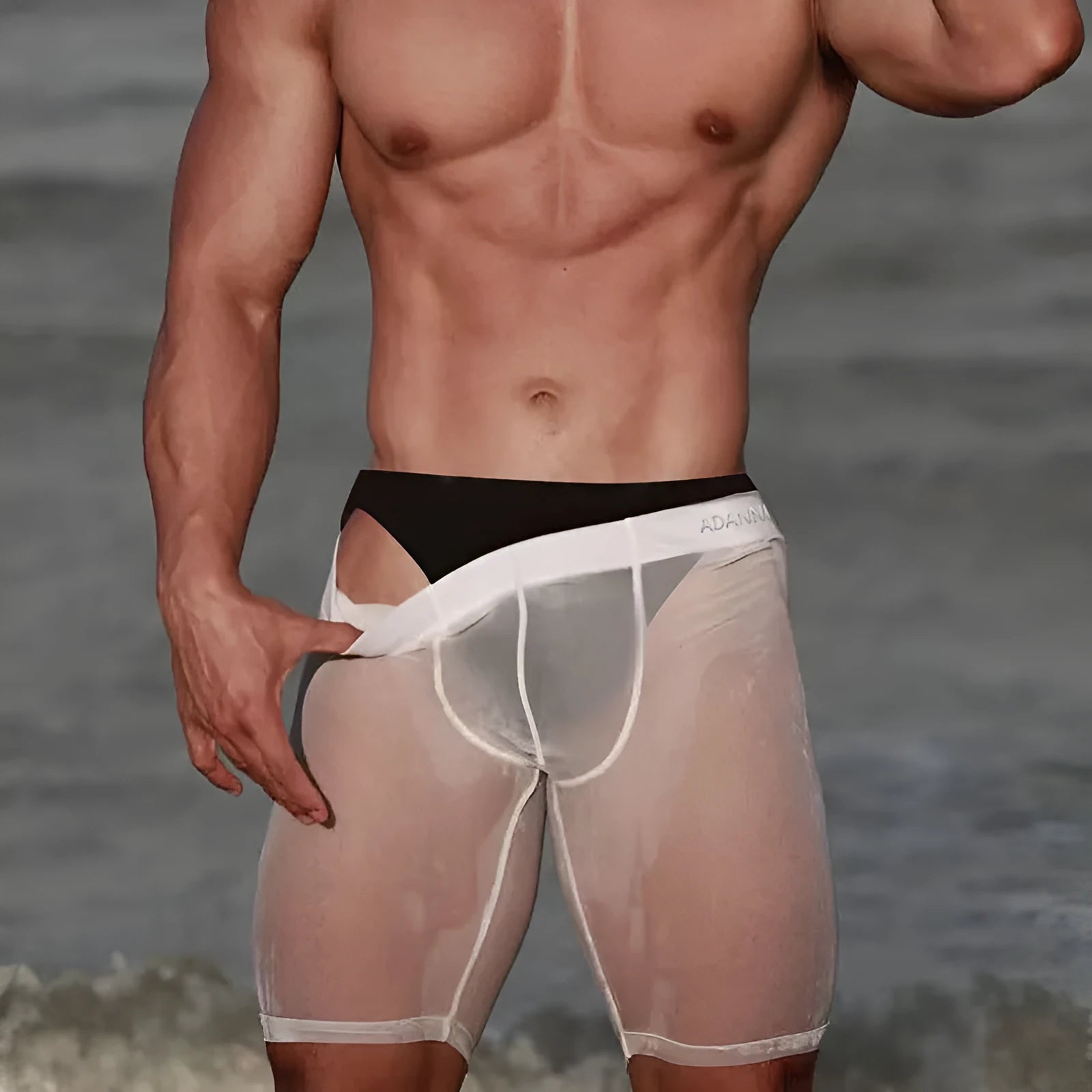 Men's solid-colour mesh shorts in black, shown laid flat to display seamless nylon knit fabric.