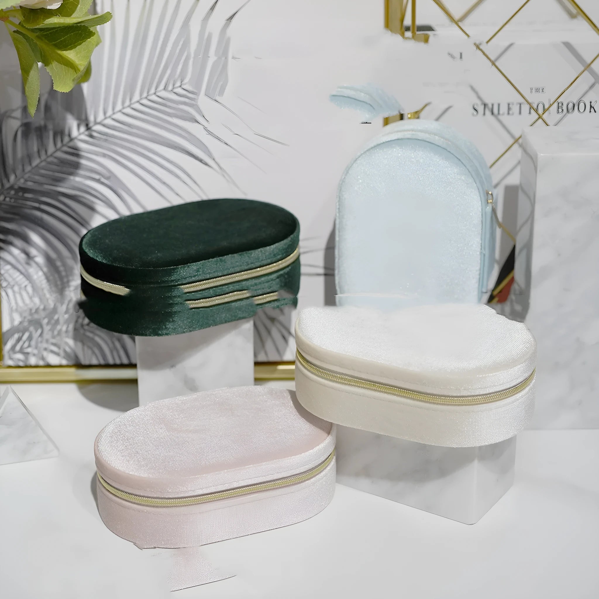 Oval velvet jewellery storage box in lake blue colour with flannel-lined interior compartments