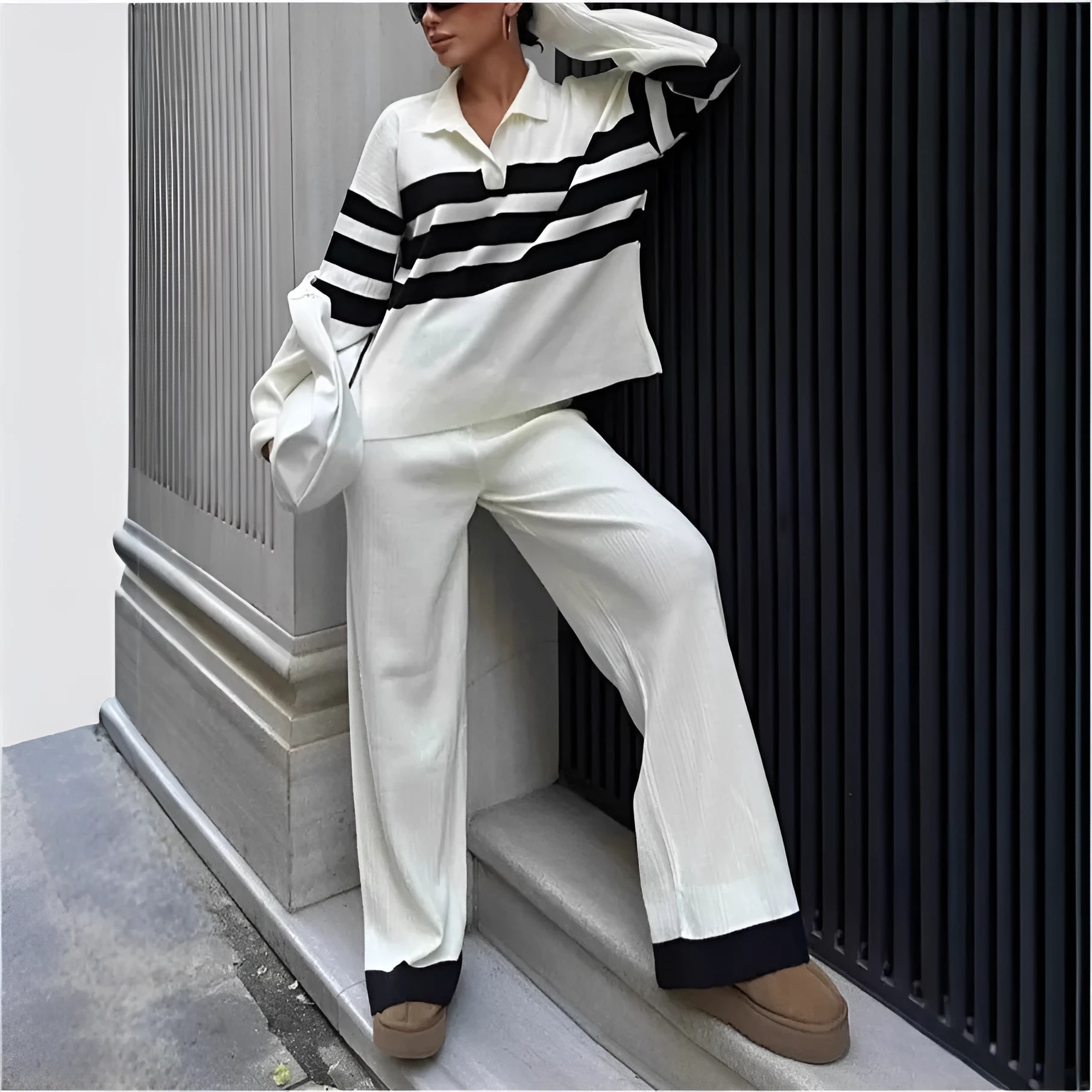 Women's black knitted two-piece set with polo collar shirt and striped matching trousers
