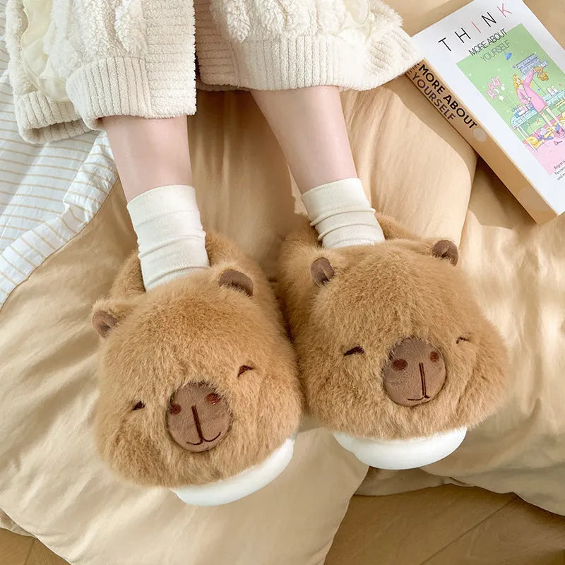 Light brown women's plush winter slippers with cartoon pattern and artificial wool lining.
