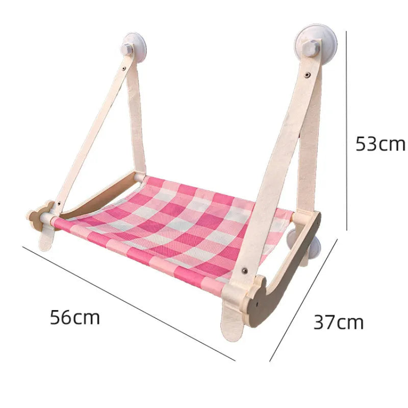 Wooden frame cat hammock with linen cushion mounted on a window, shown in green colour.