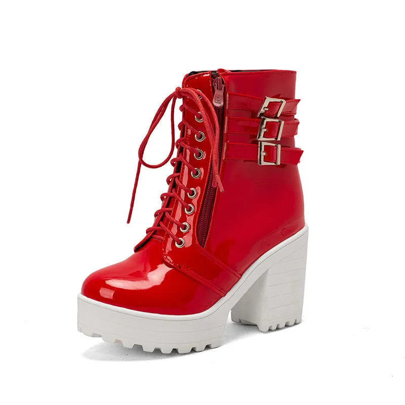 Women's black thick-heeled lace-up ankle boots with a round toe and rubber sole on a waterproof platform.