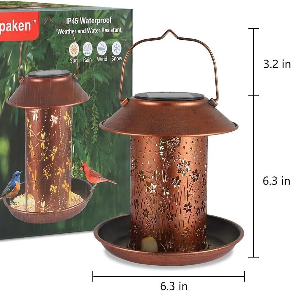 Iron solar bird feeder with hummingbird pattern and integrated LED light for outdoor garden use.
