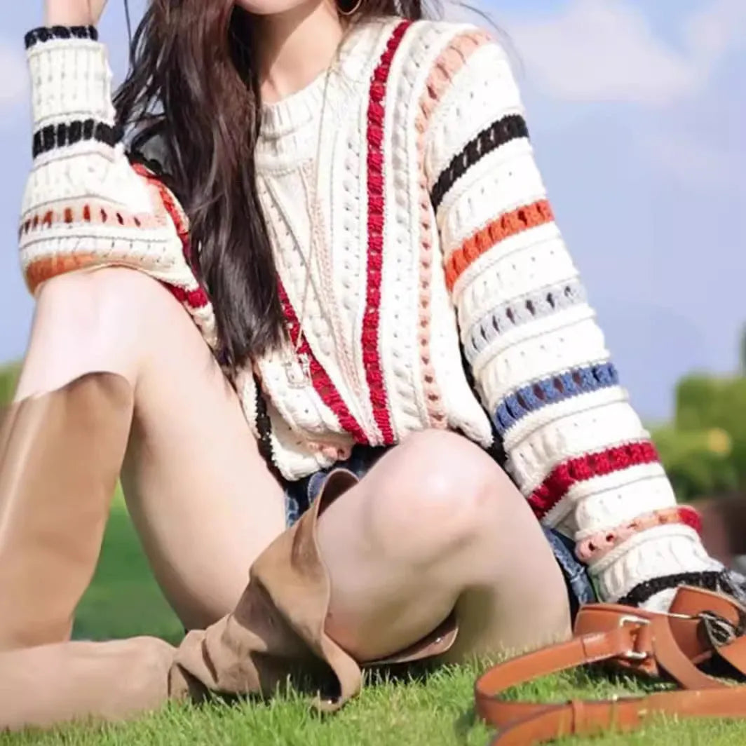 Colourful retro rainbow striped loose sweater with batwing sleeves on a hanger