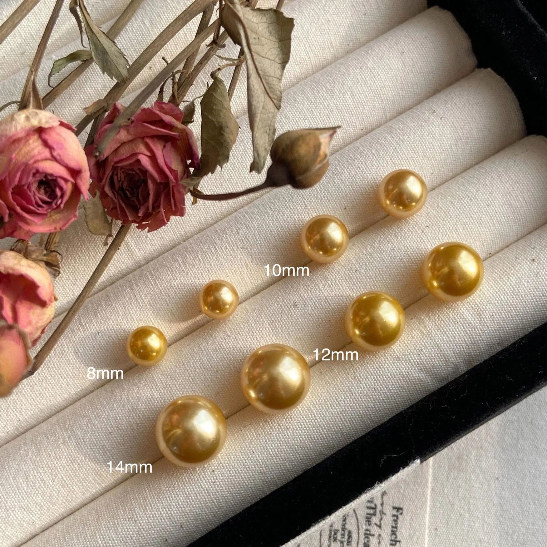 A pair of large geometric pearl stud earrings with a retro eight awn star motif on a silver setting.