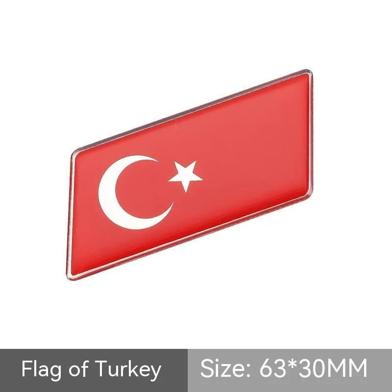 Aluminium parallelogram car sticker with national flag design measuring 6.3 by 3 cm