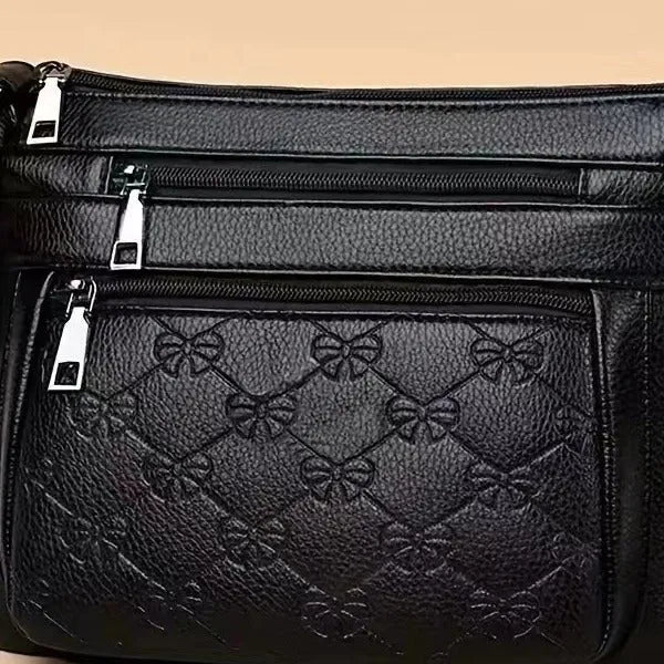 Butterfly black PU leather women's crossbody messenger bag showing embossed pattern and horizontal square shape