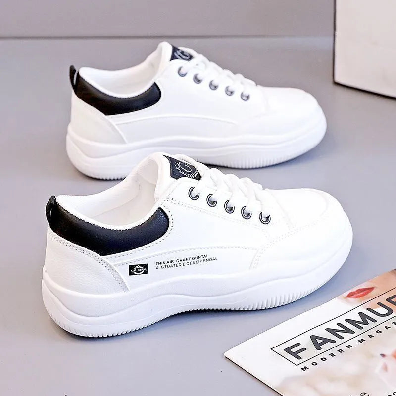 Women's white Korean-style low-top pumps with cross straps and round toe on a rubber sole.