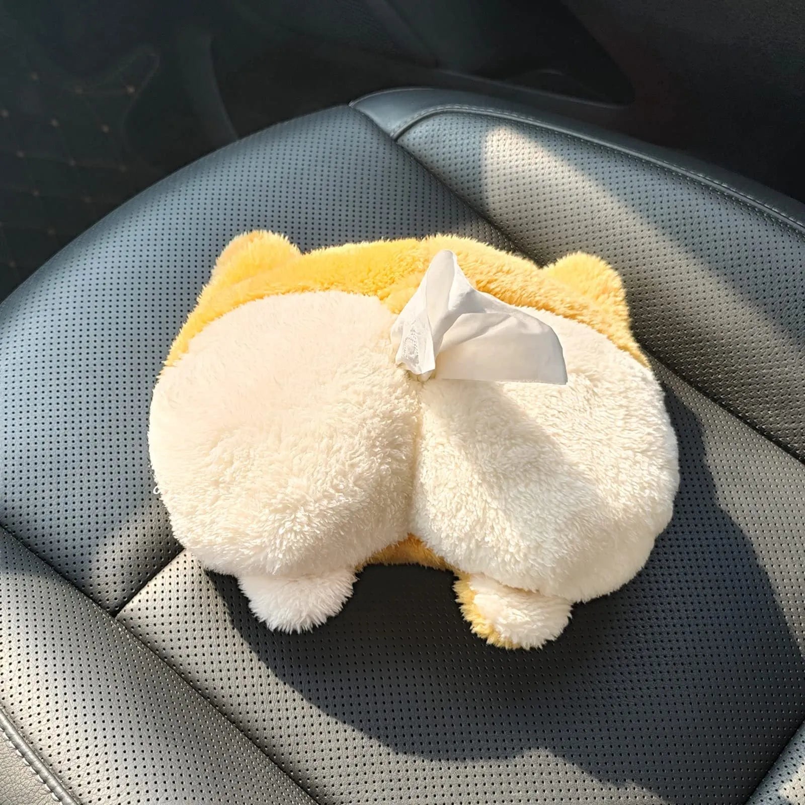 Yellow corgi butt-shaped polyester tissue box cover hanging on a car sun visor.