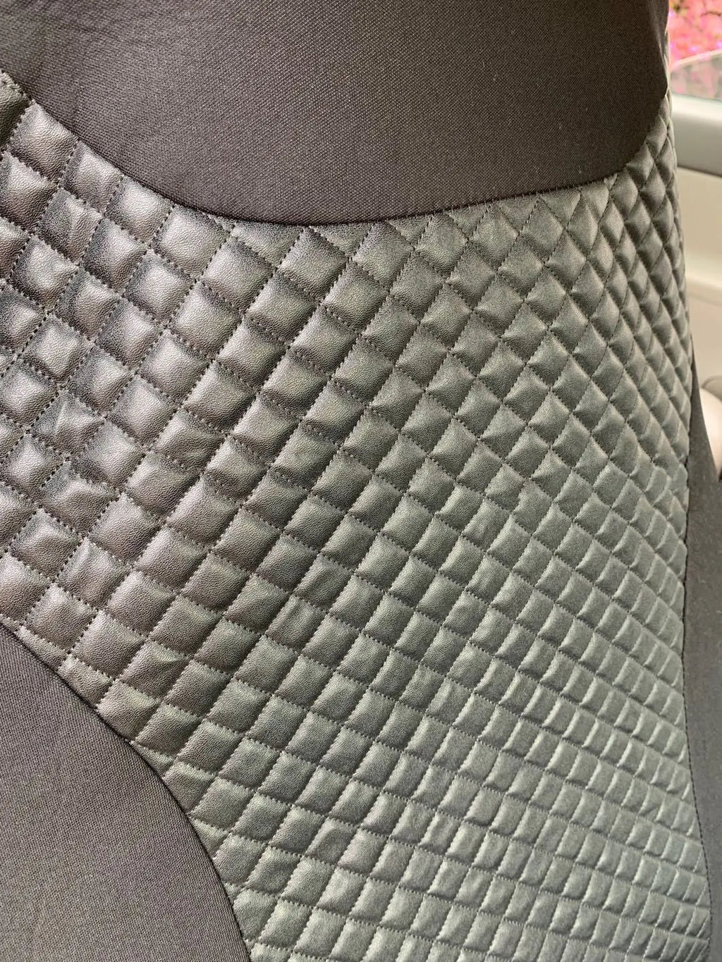 Black quilted universal car seat cover made from PU and polyester fabric with sponge composite.