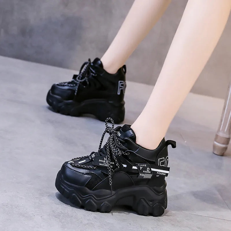 White and black women's low-top mesh platform sports shoes with cross strap and round toe.