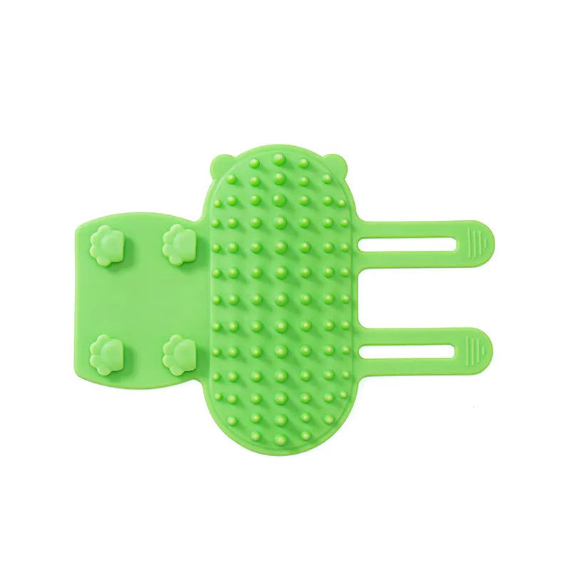 Silicone cat self-grooming brush with comb teeth and adjustable strap for table legs.