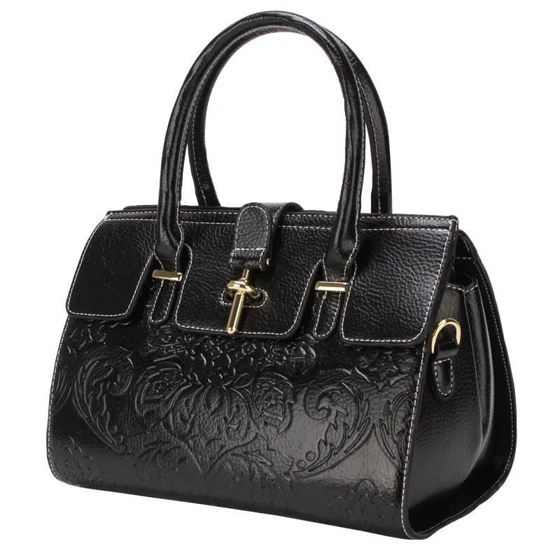 Red genuine leather oval crossbody bag with embossed design and multiple interior pockets