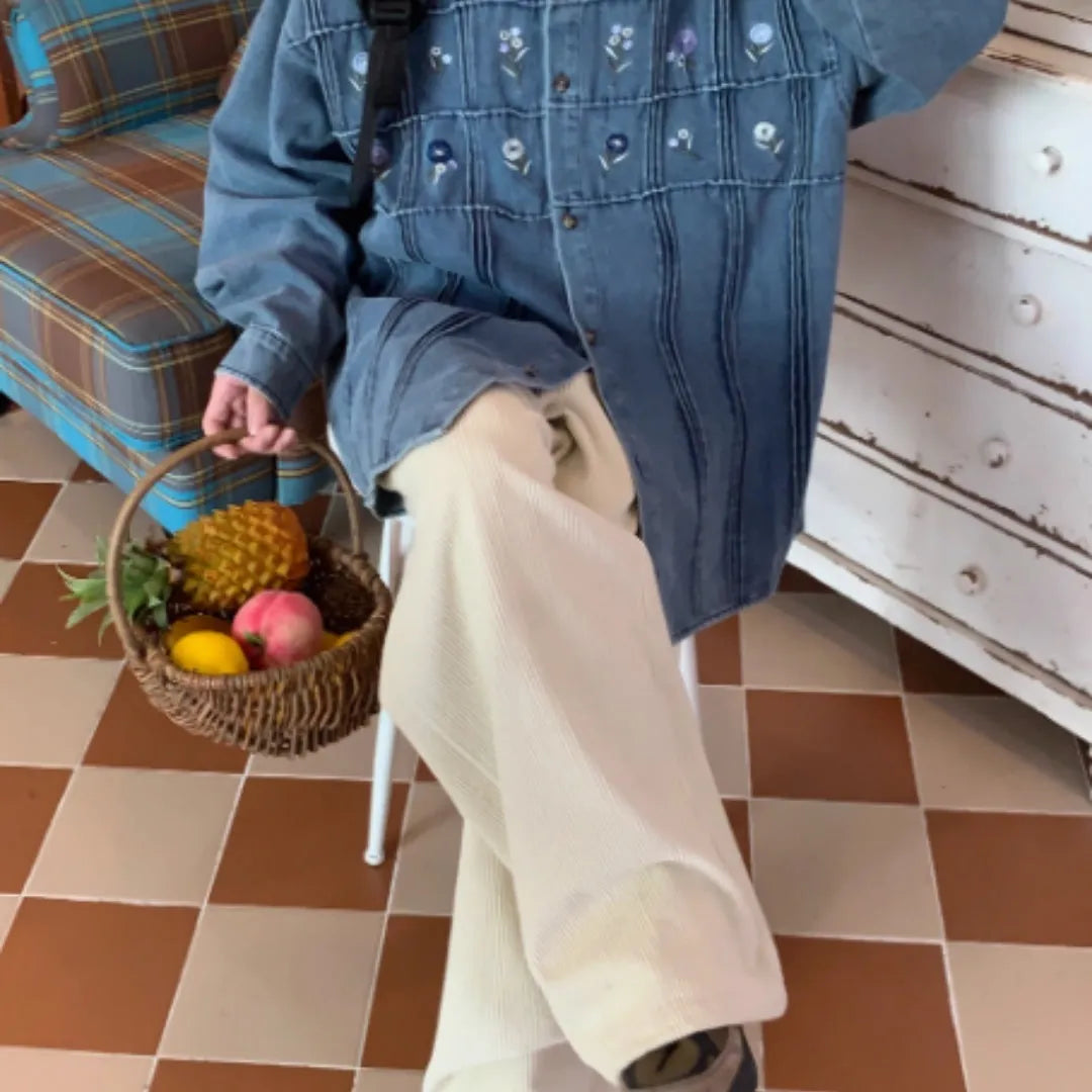 Washed blue denim long sleeve shirt with vintage small floral pleat details on the front.