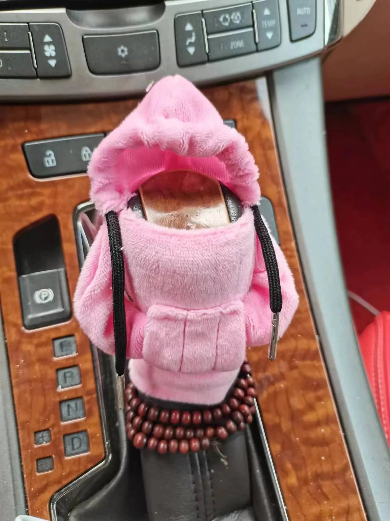 Soft Dutch velvet car gear handle cover in multiple colours on a gear stick.