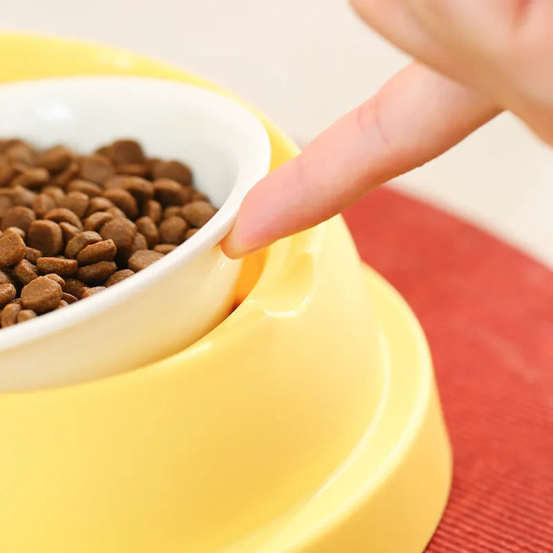 Grey and yellow dual pet food bowl with raised design for neck protection