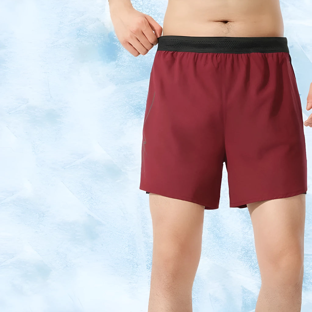 Men's solid colour low-waist basketball shorts made from polyester fabric.