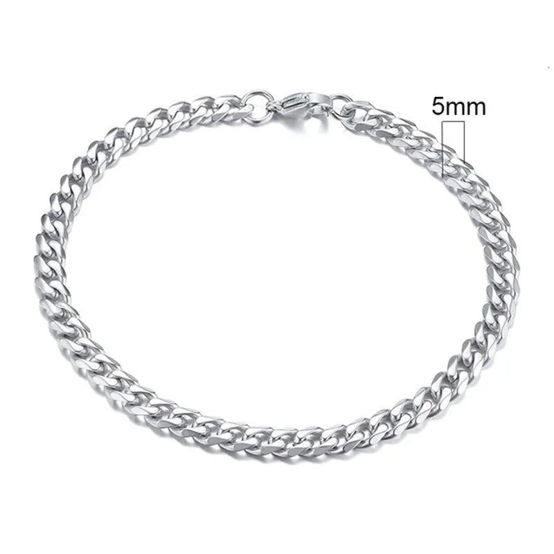 Six-sided geometric link metal bracelet in gold colour on a wrist.