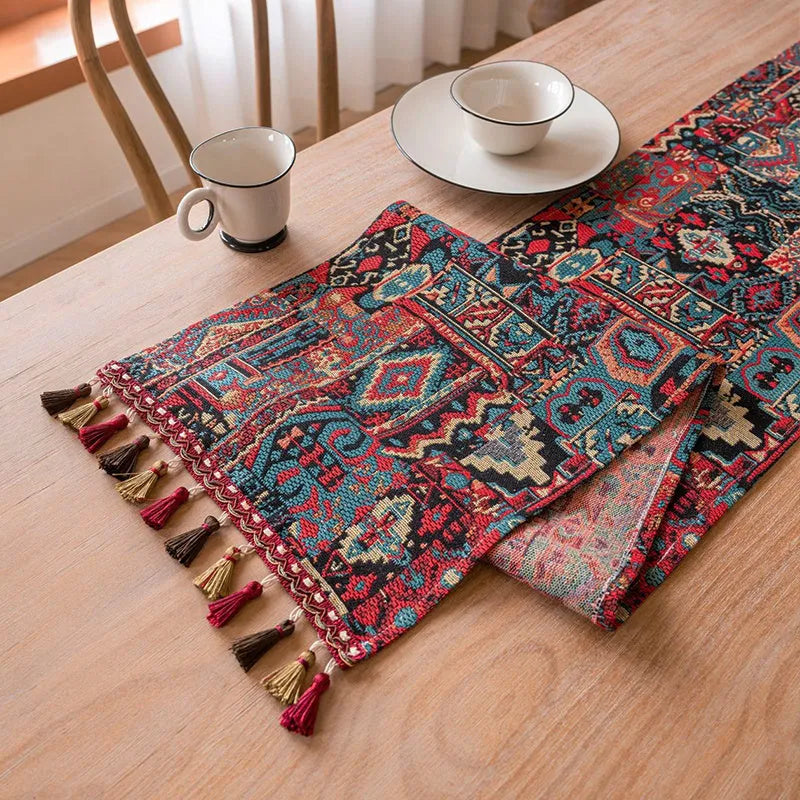 Dark blue striped Nordic jacquard bouquet table runner with tassel trim laid flat on a table.