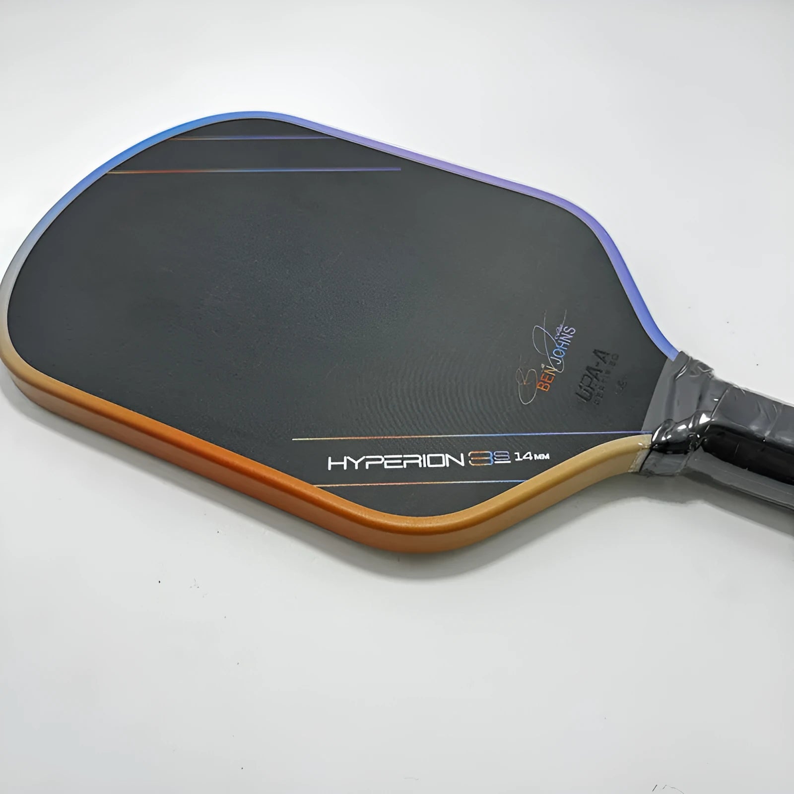 Carbon fibre pickleball racket with multi-colour matte pattern, showing 418mm length and honeycomb core construction.
