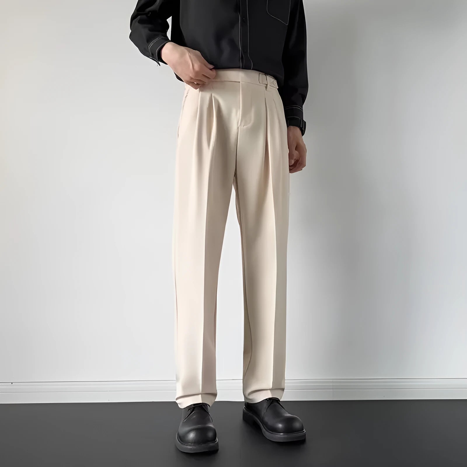 Men's straight cut loose fit suit trousers in apricot and black colours, made from polyester fabric.