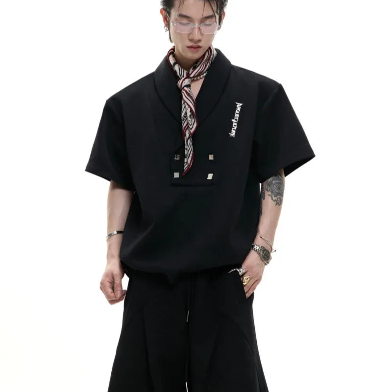 Men's dark grey cotton sports suit with metal embellishments, V-neck padded shoulders, short sleeves, and matching shorts